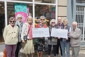 Presentation outside the PDSA shop.Chris Broughton, Pam Martin, Barbara Murphy, Margaret Hill, (RSCW) Maria McGovern, Thomas Simpson, (lead volunteer for the PDSA shop) Nicola Ellis-Nichol (PDSA shop Manager), Jim Murphy