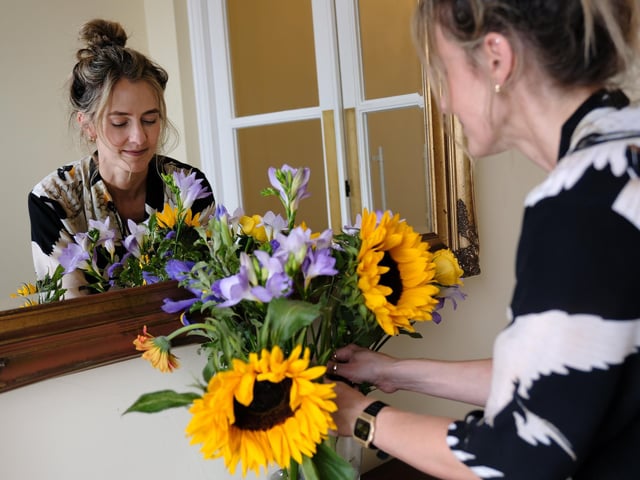 Owner Steph Allen places flowers in the entrance