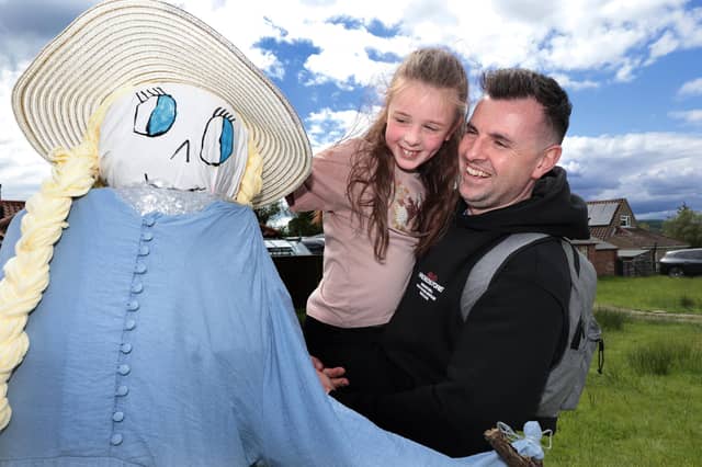 Mike and daughter Maddie enjoy the displays at Goathland Scarecrow Festival. Photo: Richard Ponter