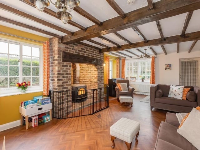 The spacious beamed lounge with feature fireplace