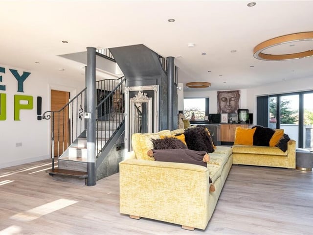 The open plan interior with feature staircase to the first floor.
