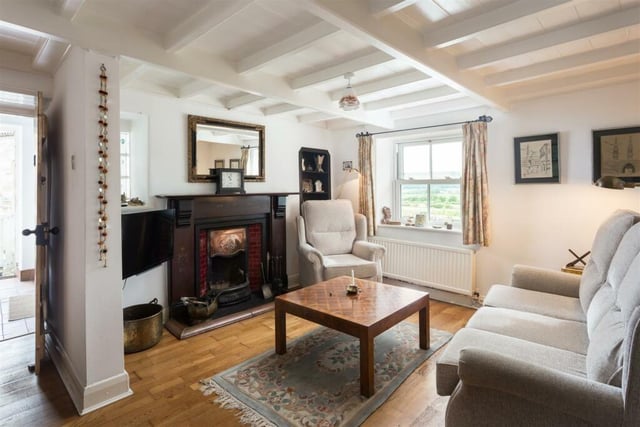 The beamed cottage interior features stunning fireplaces.