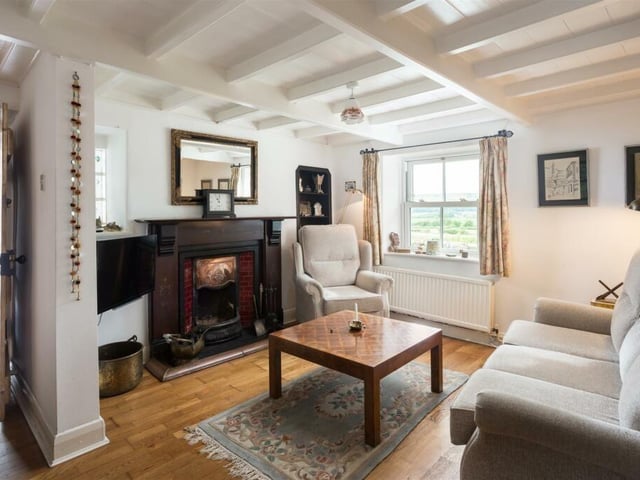 The beamed cottage interior features stunning fireplaces.