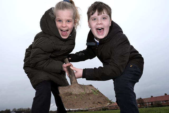 Two pupils excited to be digging ready to plant the trees.