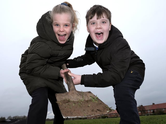 Two pupils excited to be digging ready to plant the trees.