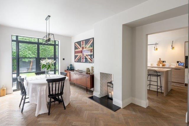 The spacious dining room has a double-sided fireplace.