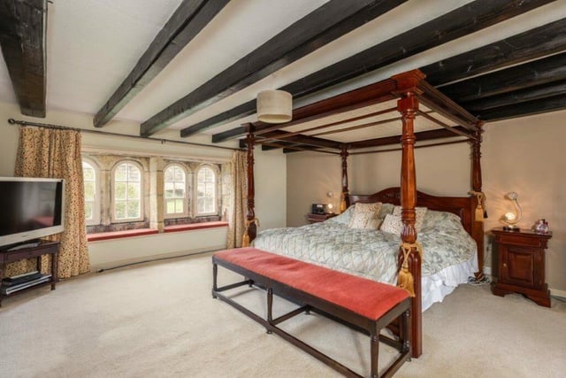 A lovely beamed bedroom with period feature windows.