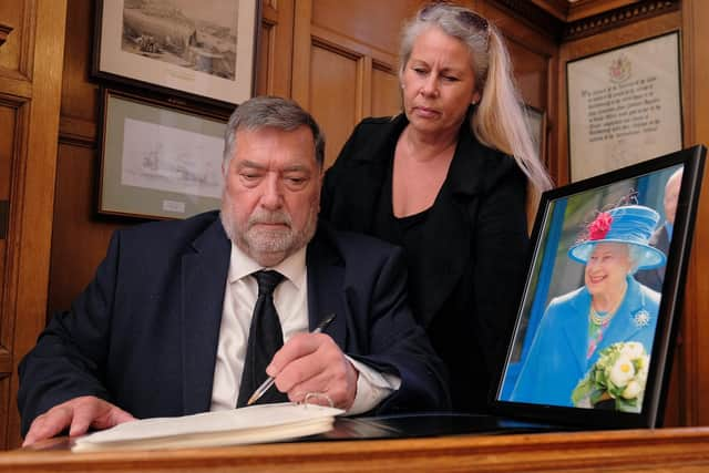 Mayor Eric Broadbent signs the book of condolence at The Town Hall with Mayoress Lynne Broadbent