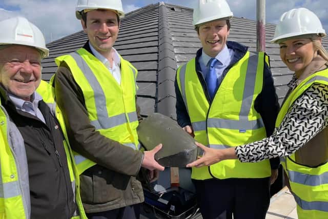 The team lays the last tile on Cayton View Care Home's roof.