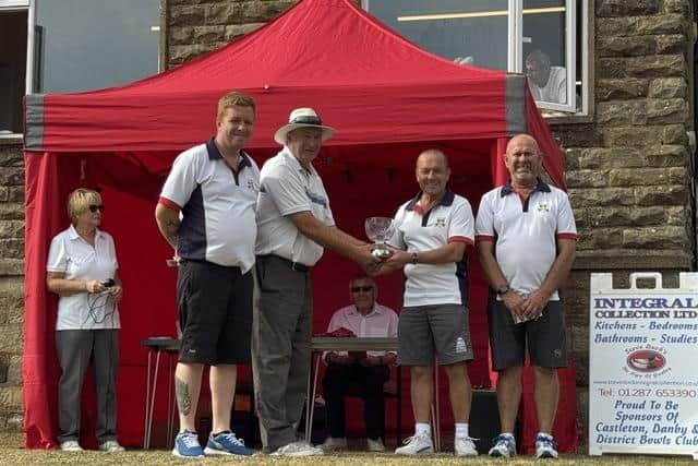 From left, the winners of the Castleton, Danby and District Bowls Club Whistlestop, M Richardson, P Kent, T Rex. Martin Muir, Club Chairman is presenting trophy.