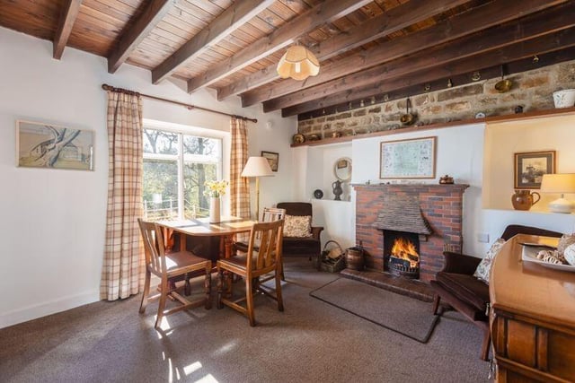 A beamed reception room with a feature brick fireplace, and lovely views.