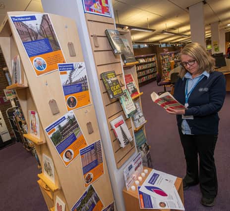 North Yorkshire libraries’ library assistant, Jo Madgwick, looks over the Holocaust Memorial Day display at Northallerton Library.