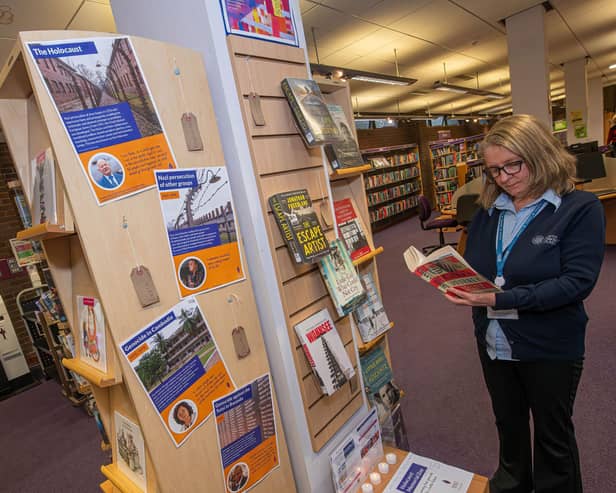 North Yorkshire libraries’ library assistant, Jo Madgwick, looks over the Holocaust Memorial Day display at Northallerton Library.