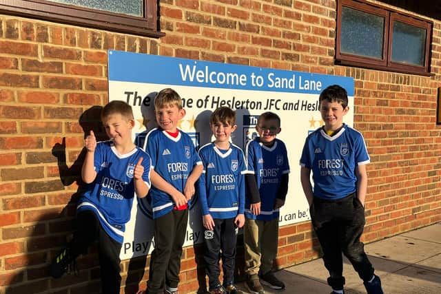 Heslerton's Comets players show off their new team kit.