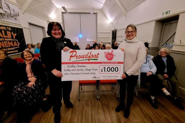 Valerie Aston presents the cheque to Newby and Scalby Village Trust