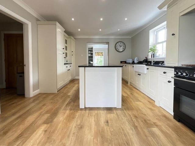 A modern kitchen with diner has a large central island.