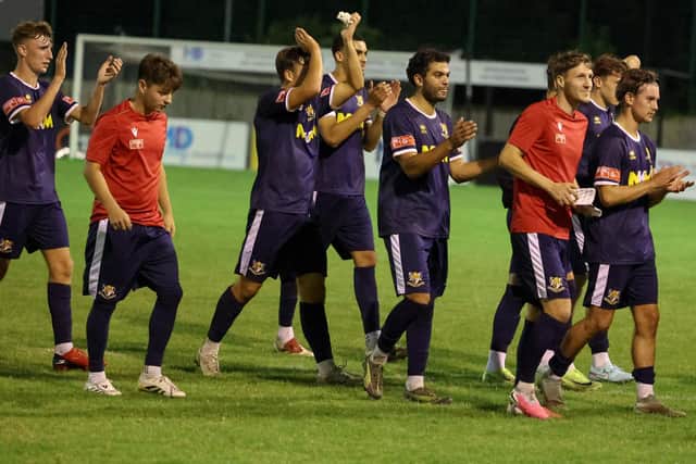 Brid Town players applaud the travelling support at Grimsby Borough.    Photo by EC Media