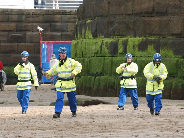 Taking part in an exercise, the Whitby Coastguard team arrive on the beach to clear the area of visitors.