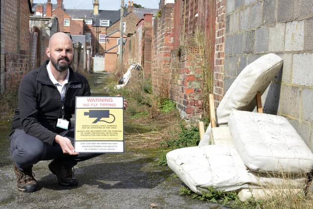 Matt Gent, the council’s service manager for environmental enforcement, with a chair and cushions found dumped in a Bridlington alley.