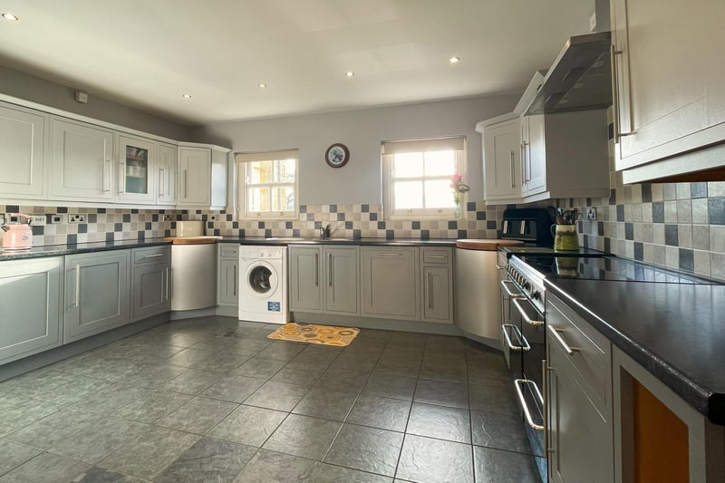 A very spacious, modern kitchen with integrated appliances.