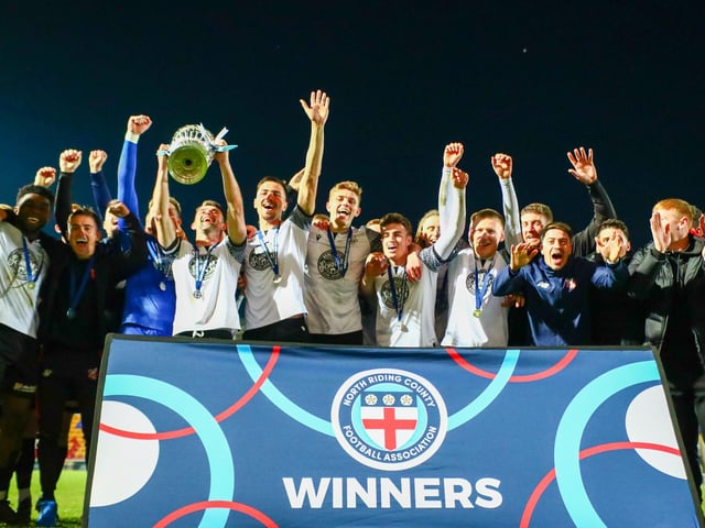 Scarborough Athletic players and coaching staff celebrate their cup final win.