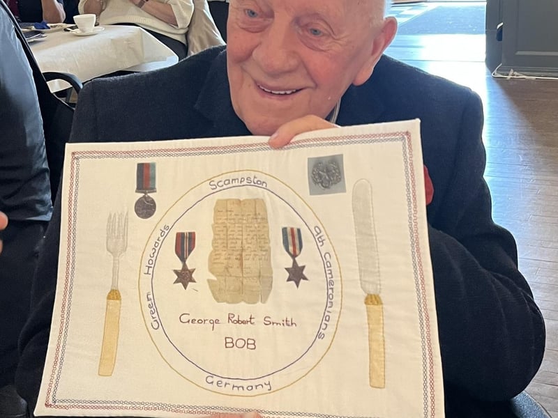Gordon Smith with embroidery for his brother Bob.