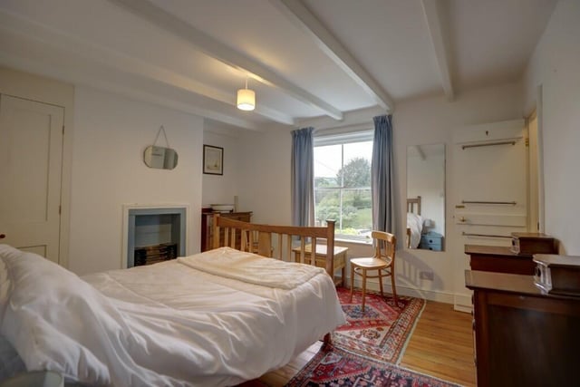 A bedroom with a fireplace feature and lovely views.