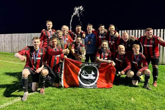 Beckett League champions West Pier celebrate their Victory Cup final win against Kirkdale United at Pickering Town on Good Friday.