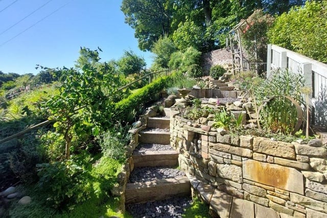A flight of steps lead up to a second garden and the area of decking.