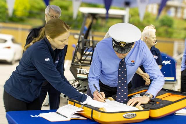 Volunteer Coxswain Steve Emmerson first to sign the RNLI scroll. - Image: RNLI/Mike Milner