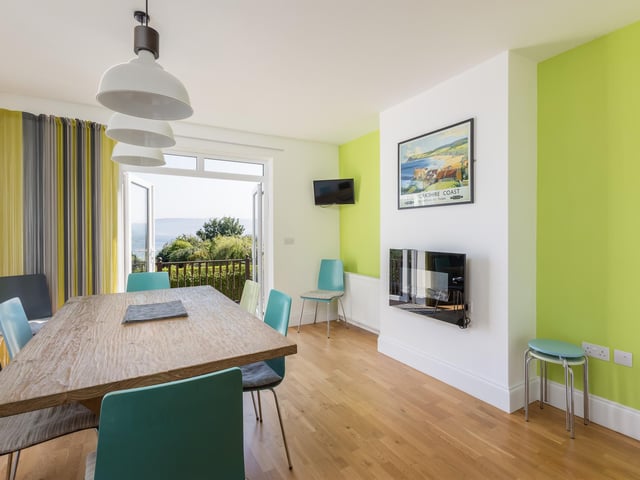 French doors open out to a seating area from the stylish dining room.