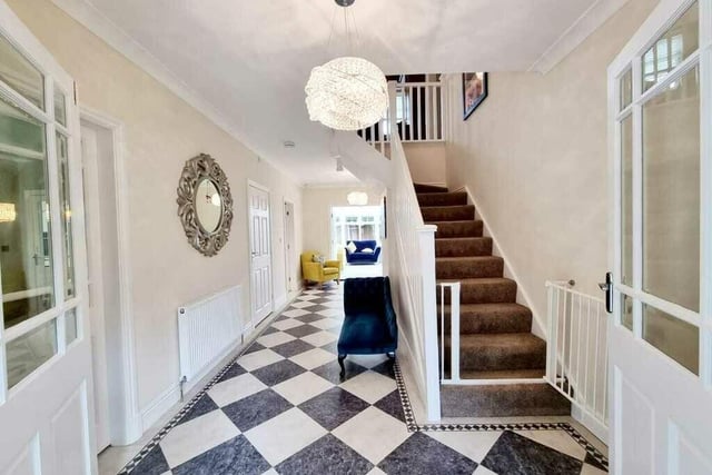 The entrance hallway with doors to ground floor rooms and staircase leading up.