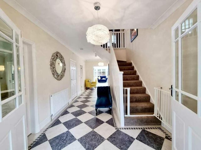 The entrance hallway with doors to ground floor rooms and staircase leading up.