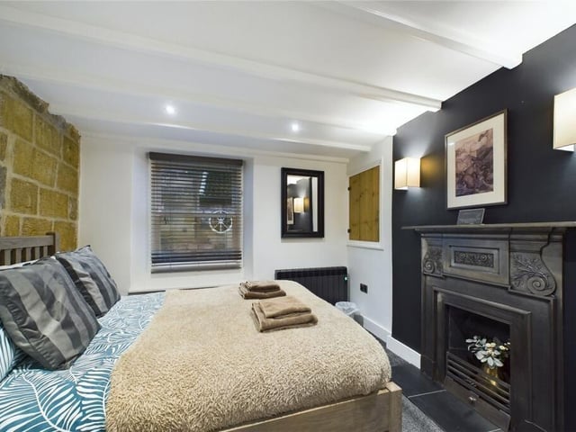 A double bedroom with feature period fireplace.