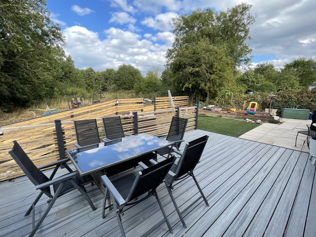 A decked seating area, with the rear garden beyond.