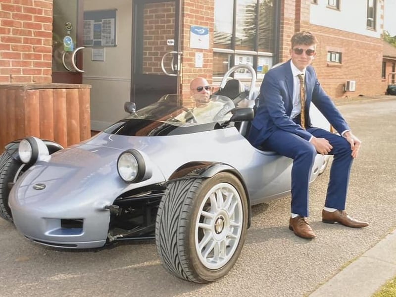 Looking cool with a fab car and sunnies on.