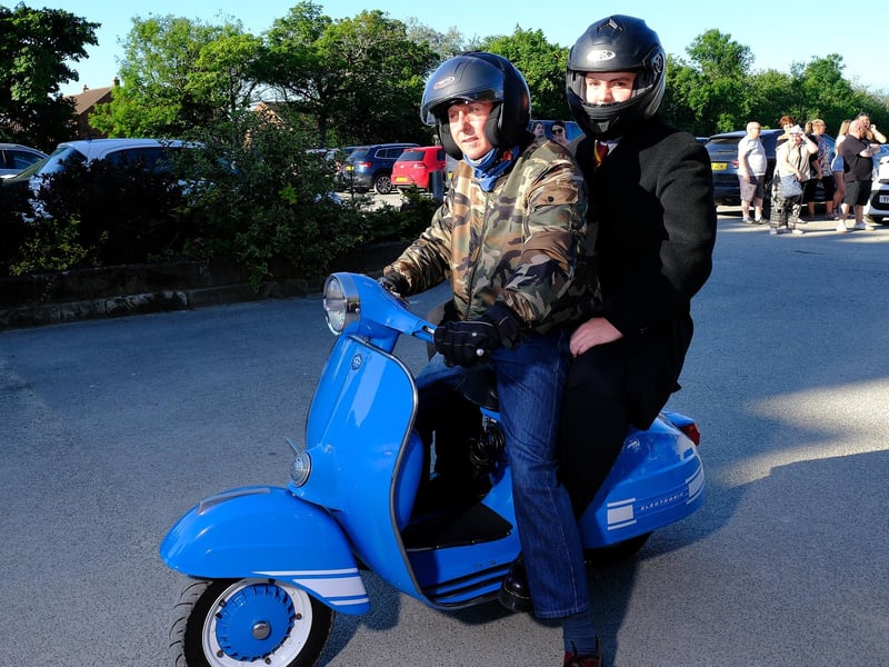 Students arrive by scooter.