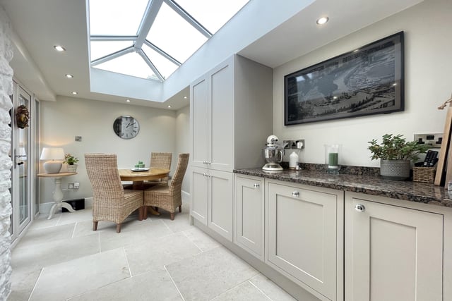 A bright dining area has French doors out to the courtyard garden.