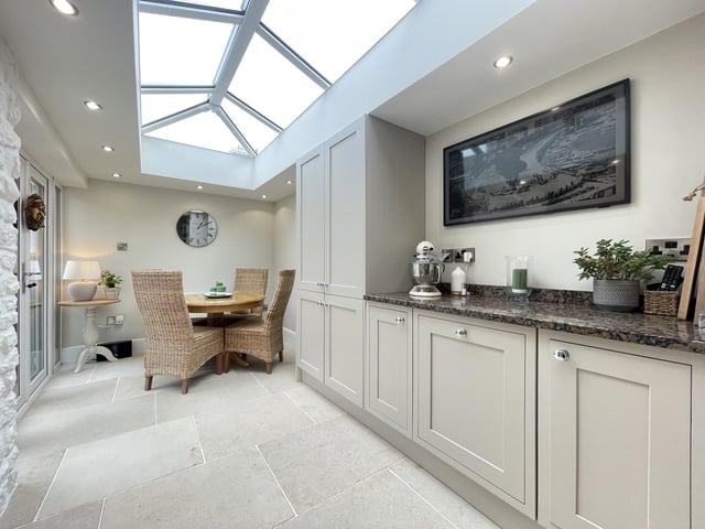 A bright dining area has French doors out to the courtyard garden.