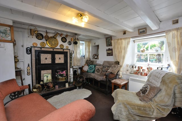 The snug, beamed sitting room within the cottage.
