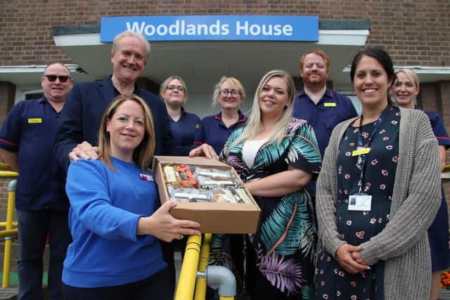 Staff at Saint Cecilia’s and hospitals with one of the hampers.