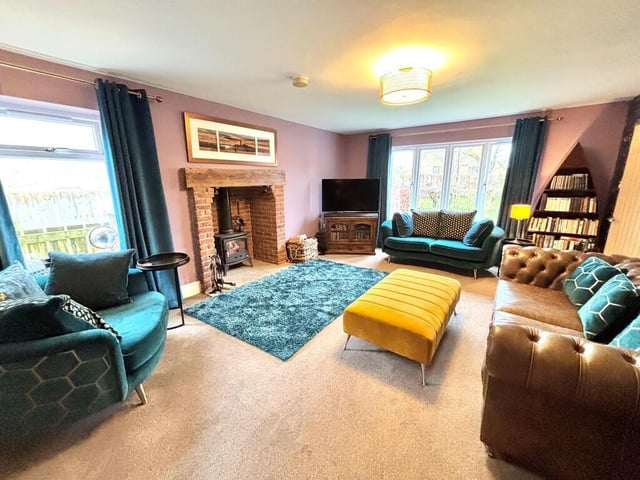The lounge has a solid fuel stove within a feature fireplace.