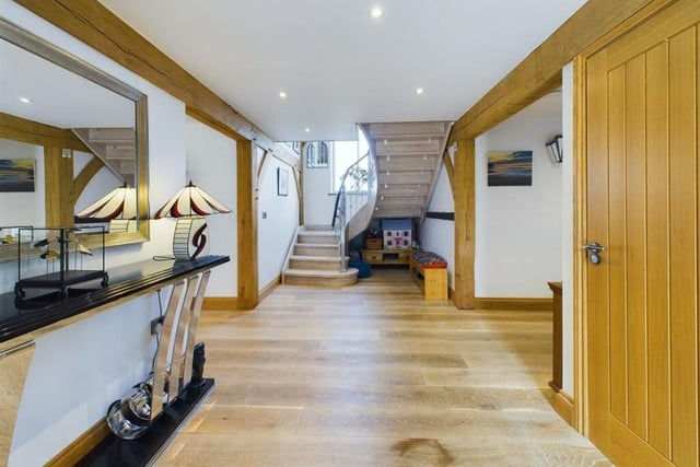 The spacious hallway with bespoke staircase.