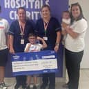 Harley Muscroft with the cheque raised from a sponsored walk, presented to staff at James Cook Hospital.