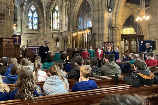 Youngsters from Whitby area schools take part in worship in church.