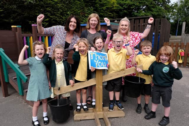 Castle Employment Manager Mel Benson, Reception Teacher Emma Creaser and Castle Representative Emma Horton with cheering pupils.