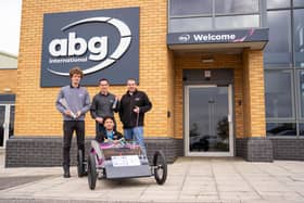 Apprentices from ABG proudly holding their first place trophy next to their winning sopabox.