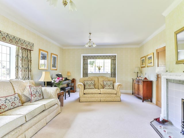 Natural light floods in to this comfortable lounge with focal fireplace, through its sizeable windows.