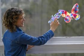 Galleries learning officer Kyra Stewart with crafted butterflies and bugs
