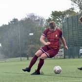 Bridlington Rovers Millau, maroon kit, on the ball against Elloughton Blackburn.